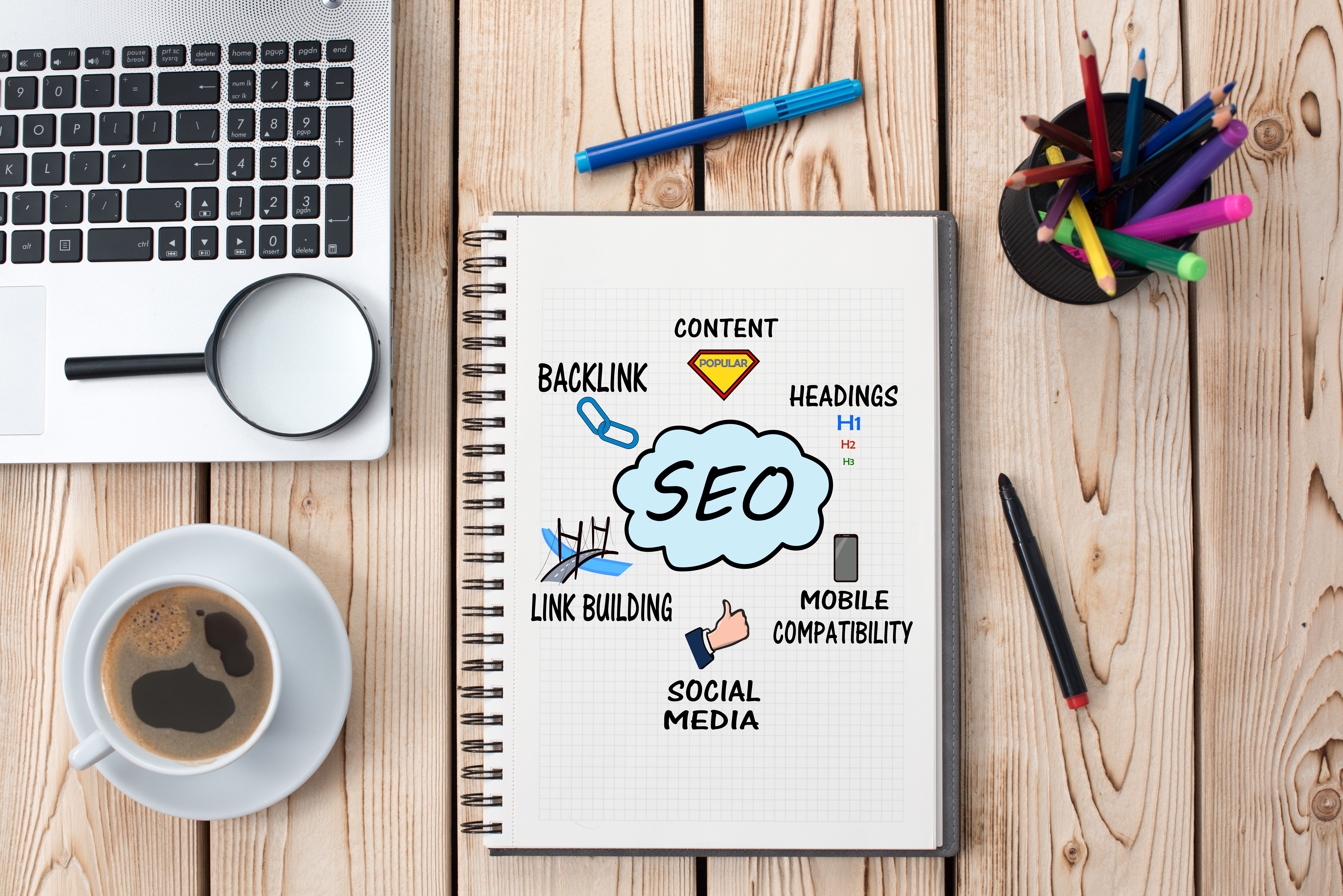 notebook on desk with SEO strategies drawn on page